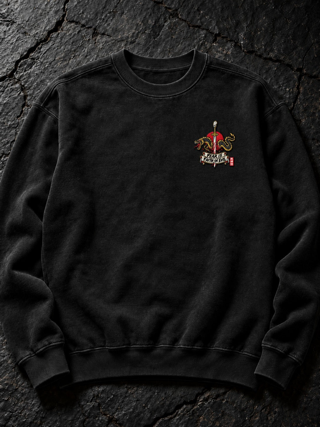 Embroidered Fear Is Faith in Evil left-chest logo (the only embroidered part) on the Pepper Nephilim Slayer Embroidered Sweatshirt