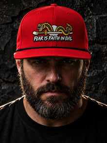 Man wearing the red and black Nephilim Slayer embroidered rope trucker hat by Nephilim Death Squad