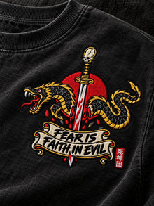 Close-up of the embroidered Fear Is Faith in Evil katana and serpent left-chest logo on the Pepper Nephilim Slayer crewneck sweatshirt