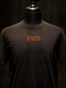 Orange Straight Bible chest print close-up on the At Thy Word Tishbite T-shirt in washed black