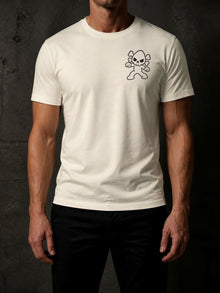 Man wearing the Ivory Nephy Comic Book Collage T-shirt (Tultex 202), front view with a small 3.75 in Nephy skull mascot print on the left chest