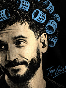 Print detail of the Play With My Emotions bootleg graphic tee: blue hair rollers, cream halftone portrait and Top Lobsta script