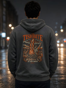 Man on a rainy city street at night wearing the Straight Bible At Thy Word Tishbite 850 vs 1 hoodie in Pepper, showing the Elijah back print