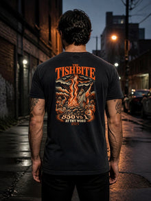 Man wearing the Straight Bible At Thy Word Tishbite 850 vs 1 T-shirt showing the back print in a city alley