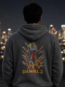 Man on a city rooftop at night wearing the Straight Bible Daniel 2 graphic hoodie in Pepper, showing the Daniel 2 statue back print