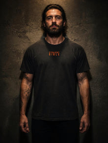 Model wearing the Straight Bible At Thy Word Tishbite 850 vs 1 Christian T-shirt in washed black, front view
