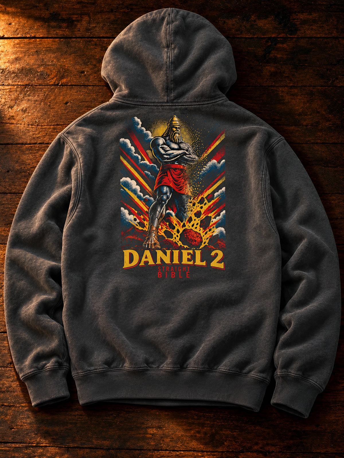 Straight Bible Daniel 2 graphic hoodie in garment-dyed Pepper, back view on dark wood