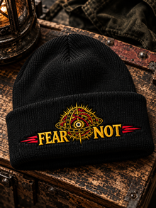 Fear Not Beanie by TopLobsta, black cuffed beanie, earlier gold and red embroidery sample, editorial view