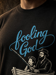 Close-up of Fooling God fishing shirt print detail with blue script and vintage halftone rowboat artwork