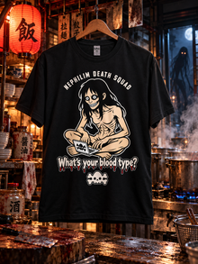 NDS What's Your Blood Type tee, black, hanging in a creepy kitchen with boiling pots and a skinwalker in the doorway