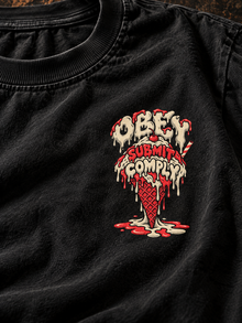Close-up of Obey Submit Comply melting ice cream chest print on black tee