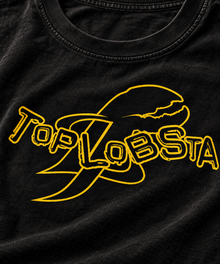 Close-up of the yellow TopLobsta wordmark and lobster claw outline print on a black T-shirt