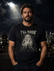 Man wearing the black Y'all Tribbin' rapture T-shirt by Nephilim Death Squad on a rooftop under a beam of light